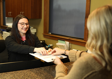 patient speaking with front desk staff member